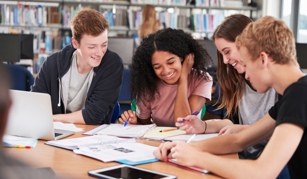 Image showing students around a table at a public library. Image showing students around a table at a public library.